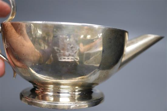 A George III silver milk jug, Emes & Barnard, London, 1812, with engraved crest, height 87mm, 163 grams.